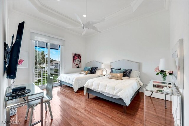 434 Conners Ave, Naples, FL 34108 - bedroom featuring access to exterior, wood finished floors, ornamental molding, ceiling fan, and a raised ceiling