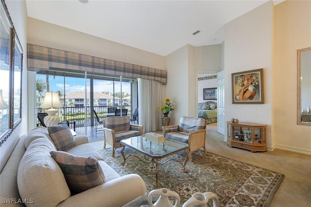 795 Bentwater Cir Unit 202, Naples, FL 34108 - living area with carpet, baseboards, and a high ceiling