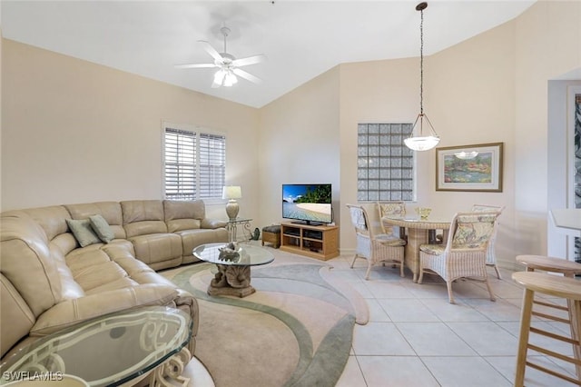 795 Bentwater Cir Unit 202, Naples, FL 34108 - living area featuring vaulted ceiling, ceiling fan, light tile patterned floors, and baseboards