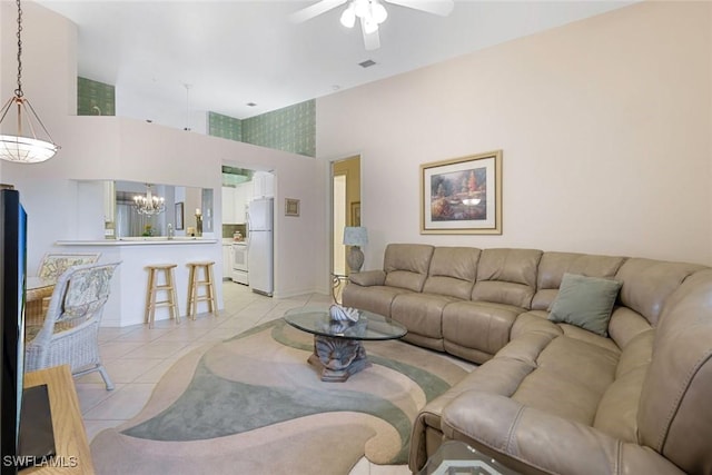 795 Bentwater Cir Unit 202, Naples, FL 34108 - living room featuring light tile patterned flooring, a chandelier, ceiling fan, and a high ceiling