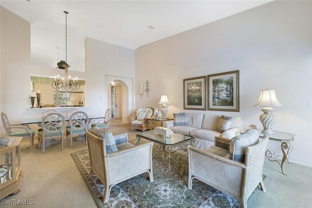 795 Bentwater Cir Unit 202, Naples, FL 34108 - living room featuring carpet flooring, arched walkways, high vaulted ceiling, a chandelier, and baseboards