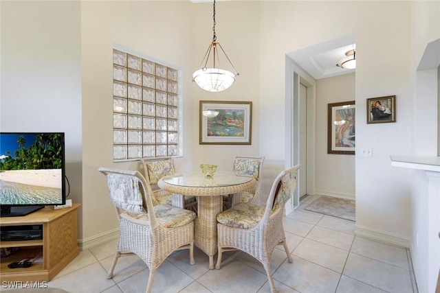 795 Bentwater Cir Unit 202, Naples, FL 34108 - tiled dining space with baseboards, a chandelier, and a tray ceiling