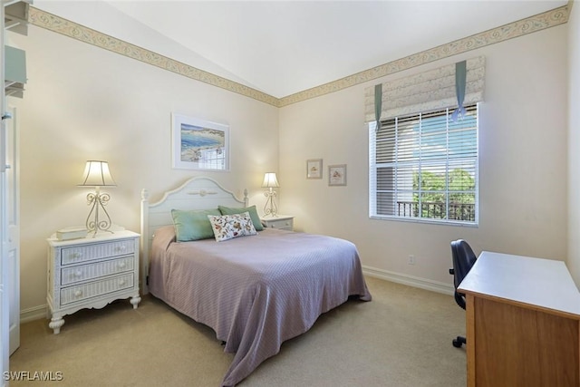 795 Bentwater Cir Unit 202, Naples, FL 34108 - bedroom featuring light carpet, baseboards, lofted ceiling, and a desk