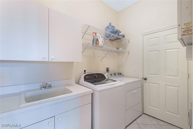 795 Bentwater Cir Unit 202, Naples, FL 34108 - laundry room with cabinet space, washing machine and dryer, and light tile patterned floors