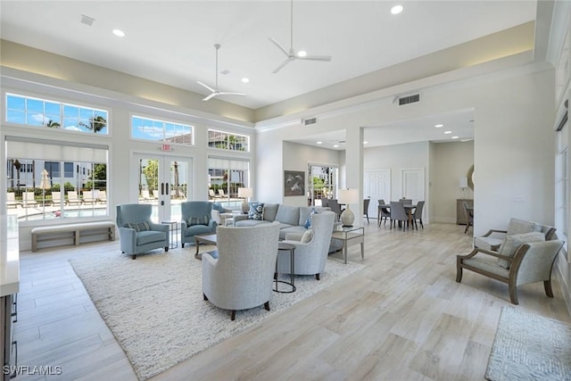 795 Bentwater Cir Unit 202, Naples, FL 34108 - living room with recessed lighting, french doors, ceiling fan, light wood-style floors, and a towering ceiling