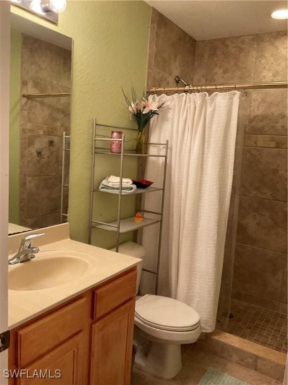 17560 Brickstone Loop, Fort Myers, FL 33967 - bathroom with toilet, a tile shower, and vanity