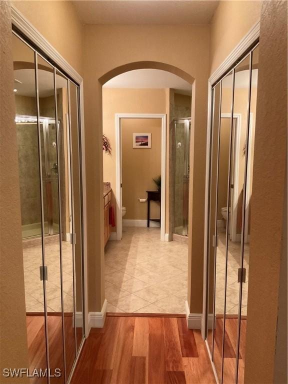 17560 Brickstone Loop, Fort Myers, FL 33967 - hallway with arched walkways and light wood-style flooring