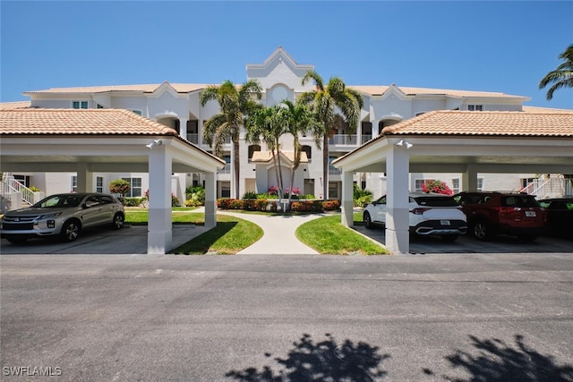 16410 Millstone Cir Unit 102, Fort Myers, FL 33908 - view of property featuring covered parking and a residential view