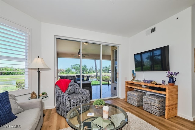 16410 Millstone Cir Unit 102, Fort Myers, FL 33908 - living area featuring wood finished floors, a ceiling fan, and baseboards