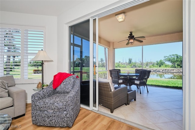 16410 Millstone Cir Unit 102, Fort Myers, FL 33908 - sunroom / solarium featuring healthy amount of natural light, a water view, and wood finished floors