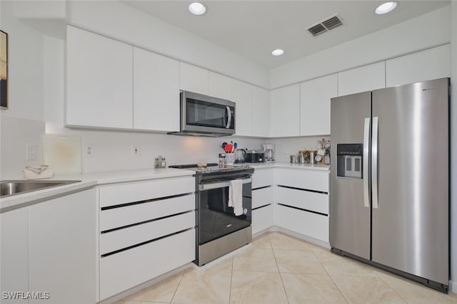 16410 Millstone Cir Unit 102, Fort Myers, FL 33908 - kitchen with appliances with stainless steel finishes, light countertops, white cabinets, a sink, and recessed lighting