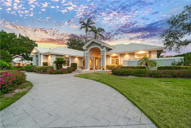 798 Brentwood Pt, Naples, FL 34110 - single story home featuring a lawn, curved driveway, stucco siding, and a tiled roof