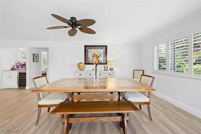 636 Park Shore Dr, Naples, FL 34103 - dining area featuring beverage cooler, light wood-style flooring, crown molding, a dry bar, and ceiling fan