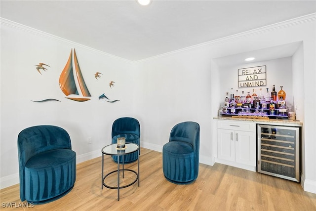 636 Park Shore Dr, Naples, FL 34103 - indoor dry bar featuring beverage cooler, light wood-style flooring, and crown molding