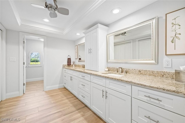 636 Park Shore Dr, Naples, FL 34103 - full bathroom with ceiling fan, double vanity, a tray ceiling, wood finished floors, and recessed lighting