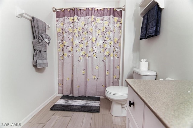 1129 NW 19th Ave, Cape Coral, FL 33993 - bathroom with toilet, vanity, curtained shower, and baseboards