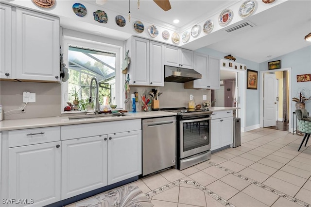 2907 Ashburn St, Lehigh Acres, FL 33972 - kitchen featuring appliances with stainless steel finishes, under cabinet range hood, light countertops, white cabinets, and light tile patterned floors