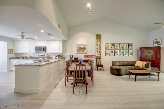 15371 River Vista Dr Unit 803, North Fort Myers, FL 33917 - dining room with a ceiling fan, lofted ceiling, light wood-type flooring, recessed lighting, and baseboards