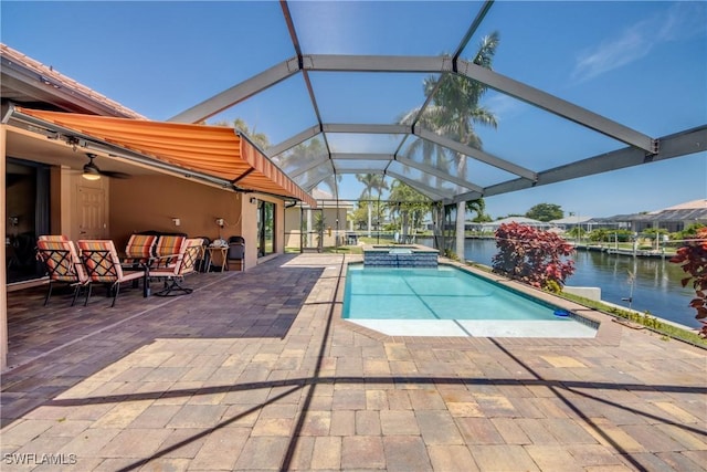 141 SW 39th St, Cape Coral, FL 33914 - view of pool with a patio, a water view, a pool with connected hot tub, and glass enclosure