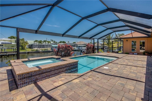 141 SW 39th St, Cape Coral, FL 33914 - outdoor pool featuring an in-ground hot tub, a patio, glass enclosure, and a water view