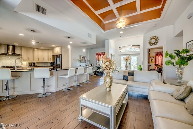 141 SW 39th St, Cape Coral, FL 33914 - living area featuring a towering ceiling, light wood finished floors, coffered ceiling, and recessed lighting