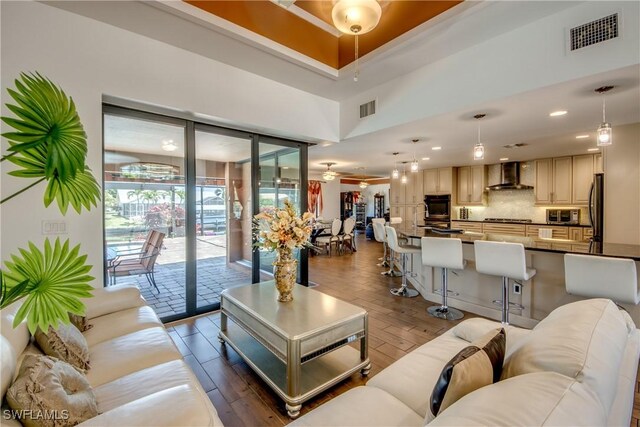 141 SW 39th St, Cape Coral, FL 33914 - living area with a ceiling fan, wood finished floors, recessed lighting, and a towering ceiling