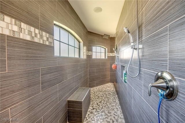 141 SW 39th St, Cape Coral, FL 33914 - bathroom featuring tile walls and a tile shower