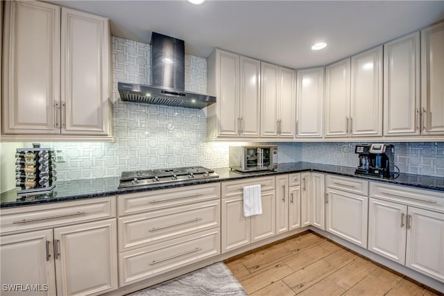 141 SW 39th St, Cape Coral, FL 33914 - kitchen featuring wall chimney exhaust hood, stainless steel gas stovetop, light wood-style flooring, tasteful backsplash, and recessed lighting
