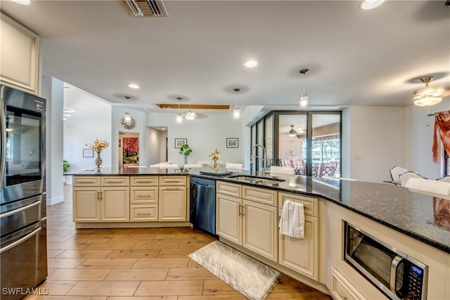 141 SW 39th St, Cape Coral, FL 33914 - kitchen featuring a sink, cream cabinetry, appliances with stainless steel finishes, a ceiling fan, and pendant lighting