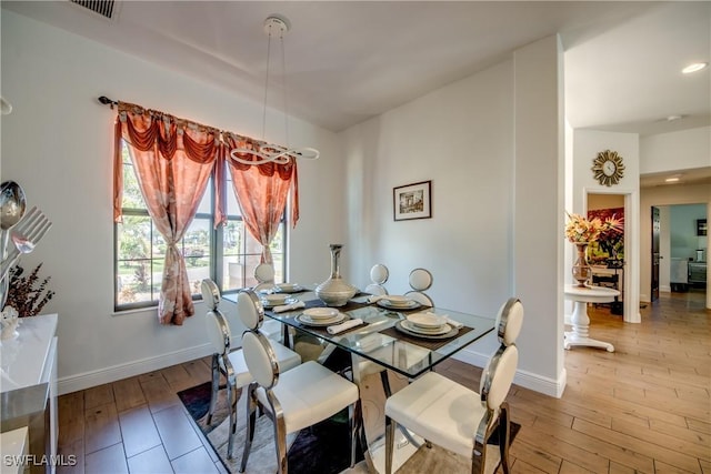 141 SW 39th St, Cape Coral, FL 33914 - dining area with baseboards and hardwood / wood-style flooring