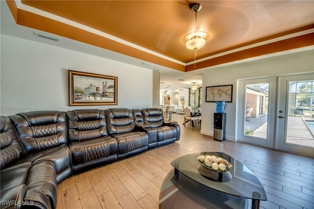 141 SW 39th St, Cape Coral, FL 33914 - living room with a raised ceiling, wood finished floors, french doors, and crown molding