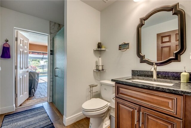 141 SW 39th St, Cape Coral, FL 33914 - bathroom featuring vanity, toilet, baseboards, and a shower with shower door