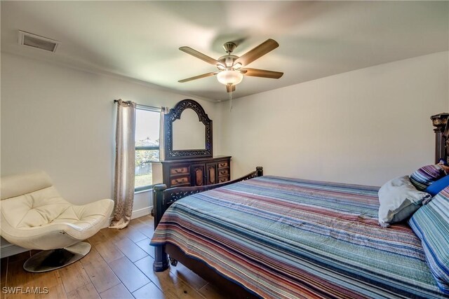 141 SW 39th St, Cape Coral, FL 33914 - bedroom featuring a ceiling fan, wood finished floors, and baseboards