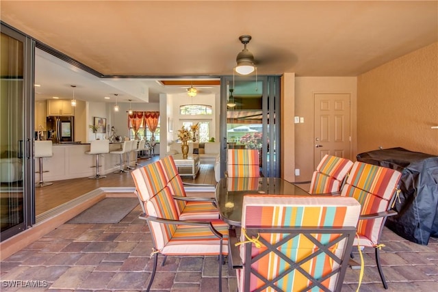 141 SW 39th St, Cape Coral, FL 33914 - dining area with ceiling fan and dark stone finish floors