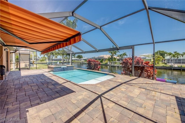 141 SW 39th St, Cape Coral, FL 33914 - view of swimming pool featuring a patio, a water view, and a pool with connected hot tub