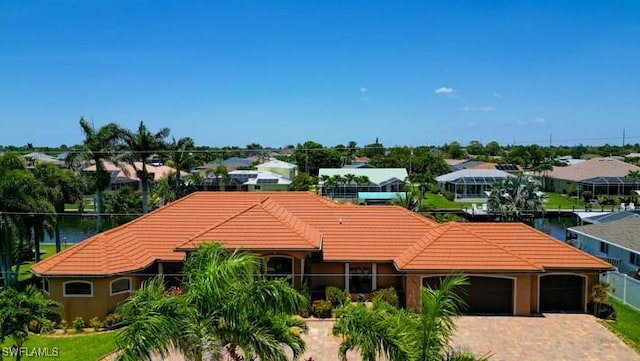141 SW 39th St, Cape Coral, FL 33914 - view of front of home with a tiled roof, a garage, driveway, and a residential view