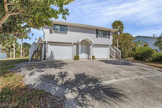 7836 Grande Pine Rd, Bokeelia, FL 33922 - view of front of property with stairs, a garage, and concrete driveway