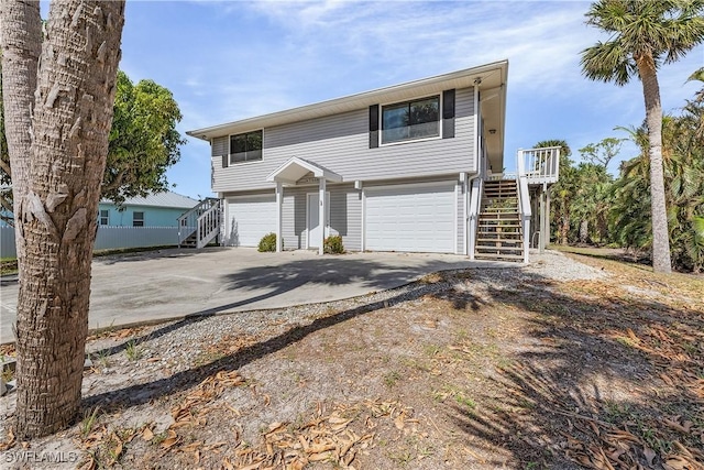 7836 Grande Pine Rd, Bokeelia, FL 33922 - view of front of house featuring stairs, an attached garage, and driveway