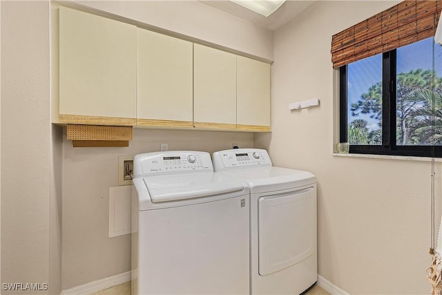 7836 Grande Pine Rd, Bokeelia, FL 33922 - laundry room featuring washer and clothes dryer, cabinet space, and baseboards