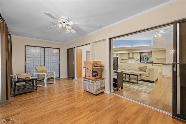 7836 Grande Pine Rd, Bokeelia, FL 33922 - sitting room featuring a ceiling fan, light wood-type flooring, and crown molding