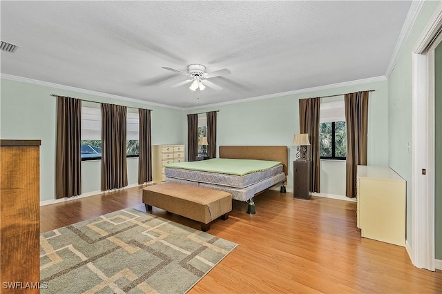 7836 Grande Pine Rd, Bokeelia, FL 33922 - bedroom with wood finished floors, ornamental molding, baseboards, ceiling fan, and a textured ceiling