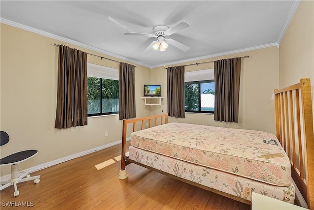 7836 Grande Pine Rd, Bokeelia, FL 33922 - bedroom featuring baseboards, multiple windows, crown molding, wood finished floors, and a ceiling fan