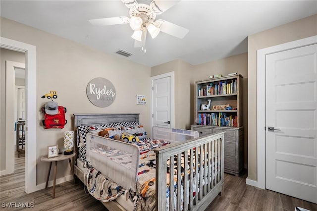 1929 NW 18th St, Cape Coral, FL 33993 - bedroom featuring baseboards, wood finished floors, and a ceiling fan