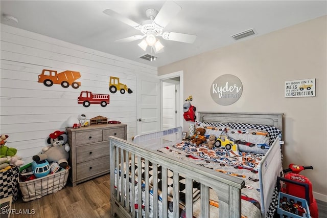 1929 NW 18th St, Cape Coral, FL 33993 - bedroom featuring wood finished floors, wooden walls, and ceiling fan