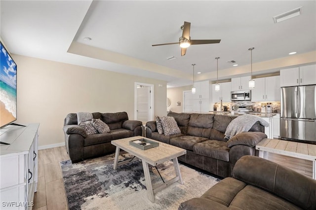 1929 NW 18th St, Cape Coral, FL 33993 - living room with a ceiling fan, baseboards, recessed lighting, and light wood-style flooring