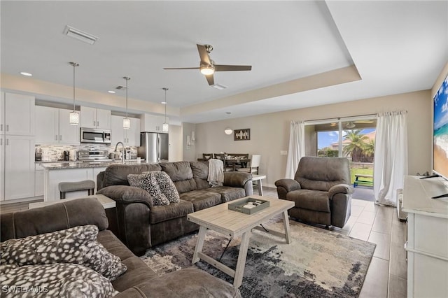1929 NW 18th St, Cape Coral, FL 33993 - living room with a tray ceiling, a ceiling fan, light tile patterned floors, and recessed lighting