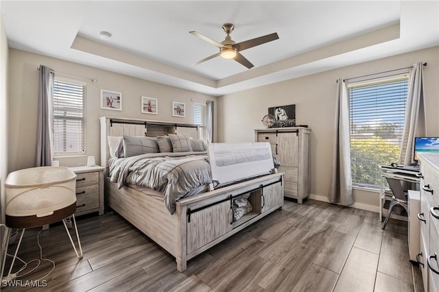 1929 NW 18th St, Cape Coral, FL 33993 - bedroom with a tray ceiling, wood finished floors, baseboards, and a ceiling fan