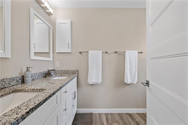 1929 NW 18th St, Cape Coral, FL 33993 - full bath featuring double vanity, baseboards, and wood finished floors