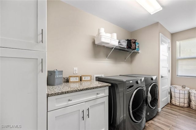 1929 NW 18th St, Cape Coral, FL 33993 - laundry area with separate washer and dryer, light wood finished floors, and cabinet space