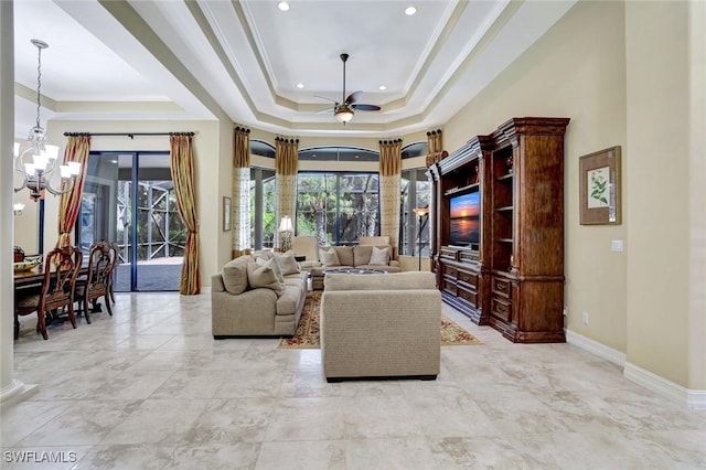 7748 Classics Dr, Naples, FL 34113 - living room featuring a raised ceiling, a ceiling fan, a chandelier, baseboards, and ornamental molding